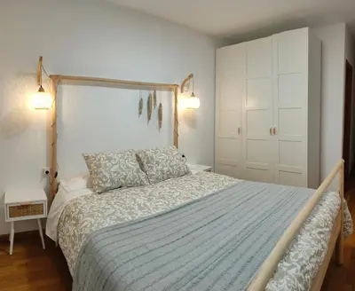 a bedroom with a bed with a blue comforter at O meo refuxio in Barreiros