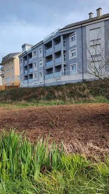 a large apartment building on top of a field at O meo refuxio in Barreiros
