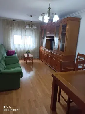 a living room with a green couch and a table at apartamento de dos habitaciones en Quiroga in Quiroga