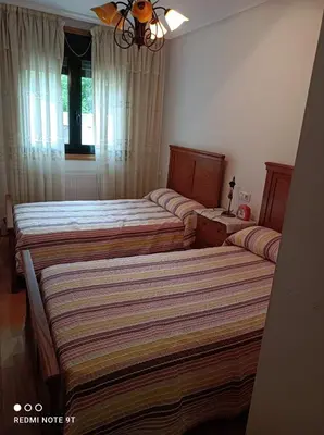 a bedroom with two beds and a window at apartamento de dos habitaciones en Quiroga in Quiroga