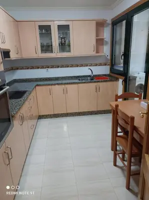 an empty kitchen with a table and a kitchen at apartamento de dos habitaciones en Quiroga in Quiroga