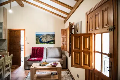 a living room with a couch and a table at El balcón de la Penela in Belesar