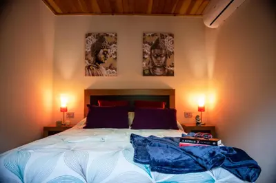 a bedroom with a bed with two pictures on the wall at El balcón de la Penela in Belesar