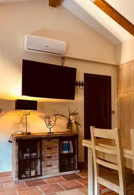 a living room with a flat screen tv on a wall at El balcón de la Penela in Belesar