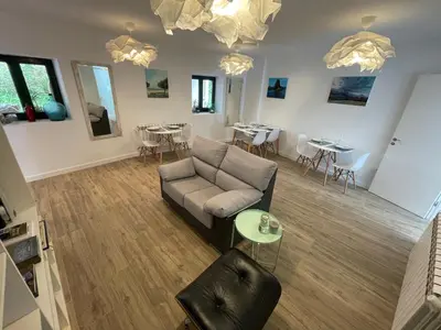 a living room with a couch and tables and chairs at Apartamentos turísticos Praia de Seselle, terraza y jardín a un paso de la playa in Ares