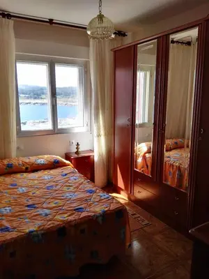 a bedroom with two beds and two windows at EnSAN CIPRIÁN Faro de Punta Atalaya in Cervo