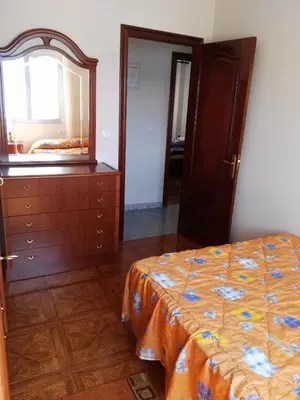 a bedroom with a bed and a dresser and a mirror at EnSAN CIPRIÁN Faro de Punta Atalaya in Cervo