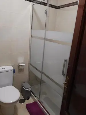 a bathroom with a toilet and a glass shower at EnSAN CIPRIÁN Faro de Punta Atalaya in Cervo