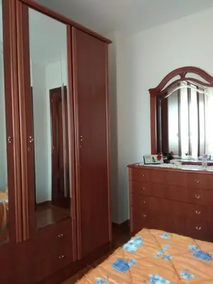 a bedroom with a dresser and a large mirror at EnSAN CIPRIÁN Faro de Punta Atalaya in Cervo