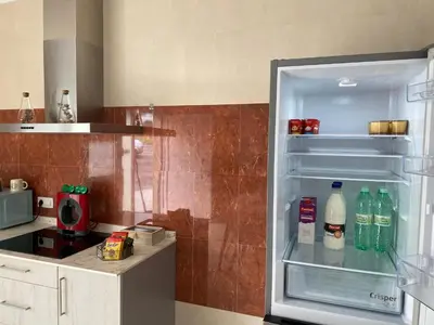 an open refrigerator with drinks in it in a kitchen at Pensión Casa Cancela in Palas de Rei