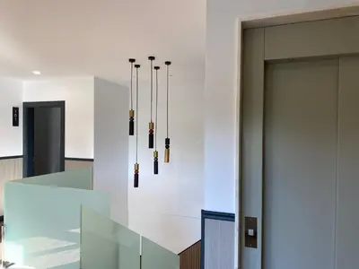 a group of chandeliers hanging from a wall at Pensión Casa Cancela in Palas de Rei