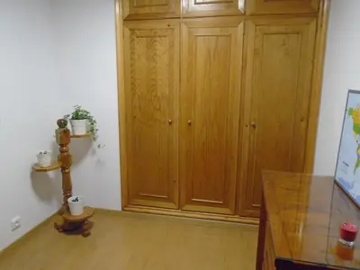 a room with a wooden cabinet and a table at Piso céntrico Pontedeume in Puentedeume