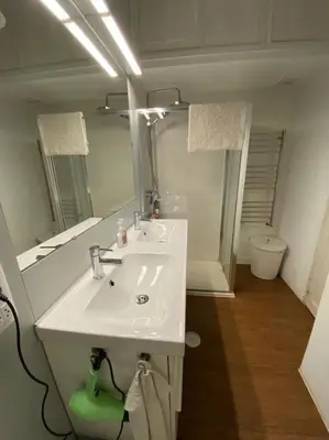 a bathroom with a white sink and a mirror at O Cerrulo Apartamento céntrico Pontedeume in Puentedeume