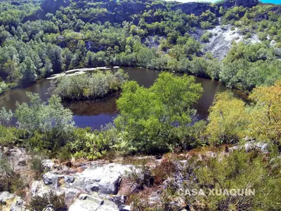 an aerial view of a lake in a forest at Casa Xuaquin in Moal