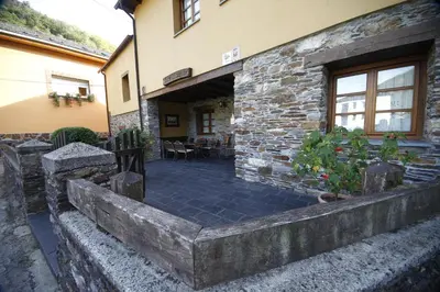 a stone building with a patio in front of it at Casa Xuaquin in Moal