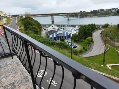 a balcony with a view of a river and a bridge at BALCON DEL EO in Ribadeo