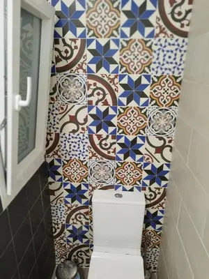 a bathroom with a toilet and a tile wall at BALCON DEL EO in Ribadeo