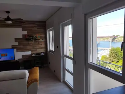 a living room with large windows and a view of the water at BALCON DEL EO in Ribadeo