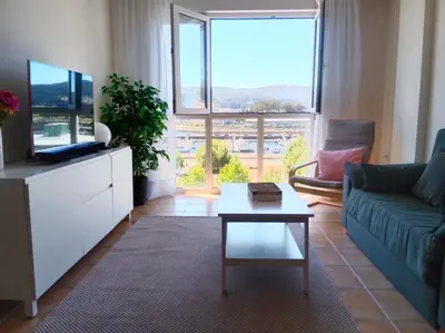 a living room with a couch and a tv and a table at El Mirador 2 in Vivero