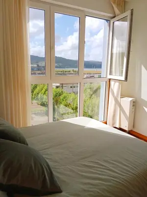 a bedroom with a bed and a large window at El Mirador 2 in Vivero