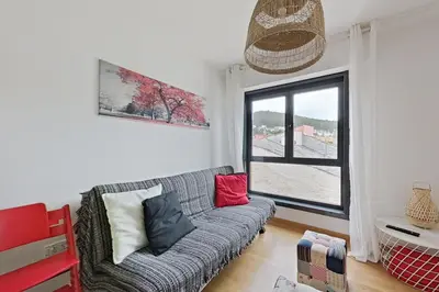 a living room with a couch and a window at Apt. p/4 en la Playa de Viveiro in Viveiro