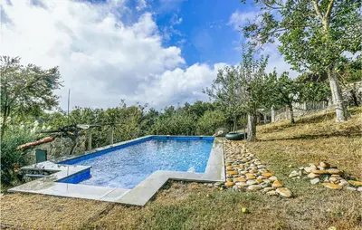 a swimming pool in the middle of a yard at 1 Bedroom Stunning Home In Galicia in Belesar