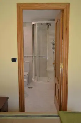 a bathroom with a shower and a toilet through a door at Acogedor piso con vistas en Sada in Sada