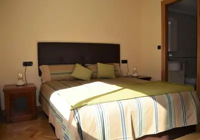 a bedroom with a large bed and two night stands at Acogedor piso con vistas en Sada in Sada