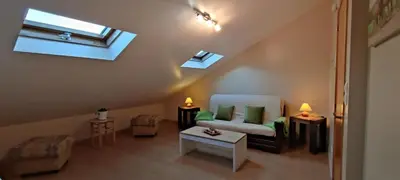 a attic living room with a couch and a window at Apartamento San Bartolo in Barreiros