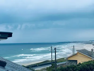 a view of the ocean from a house at Apartamento San Bartolo in Barreiros