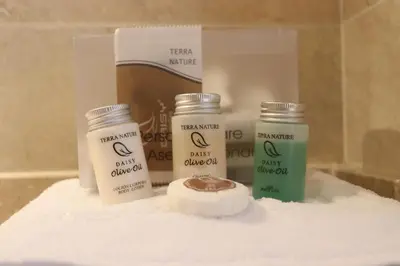 a shelf with three bottles of cream and a box of soap at Apartamento San Bartolo in Barreiros