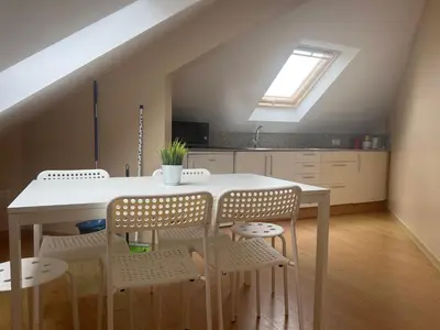 a kitchen with a table and chairs and a window at Apartamento San Bartolo in Barreiros