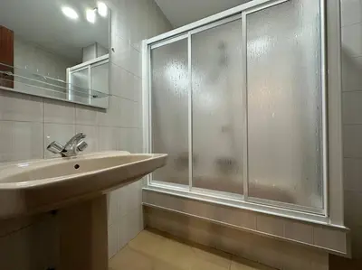 a kitchen with white cabinets and a stove top oven at Oktheway Et Suseia in Sarria