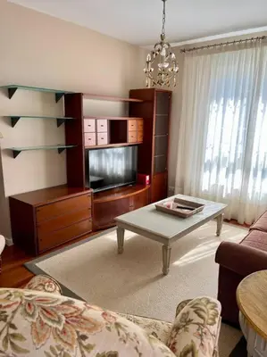 a living room with a couch and a coffee table at Piso con jardín en Ribadeo in Ribadeo