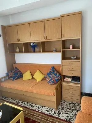 a bed in a room with wooden cabinets at Casa Roque in Monforte de Lemos