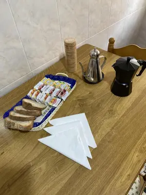 a table with a tray of bread and a plate of food at Casa Roque in Monforte de Lemos