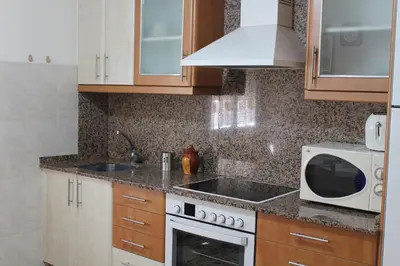 a kitchen with a microwave and a stove top oven at Casa Roque in Monforte de Lemos