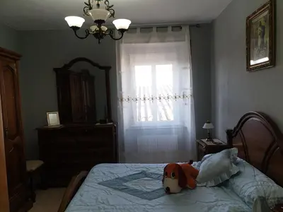 a stuffed dog laying on a bed in a bedroom at ANAMAR in Lugo