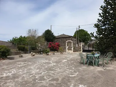 a patio with chairs and a table in front of a building at ANAMAR in Lugo