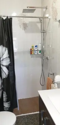 a bathroom with a shower with a toilet and a sink at ANAMAR in Lugo