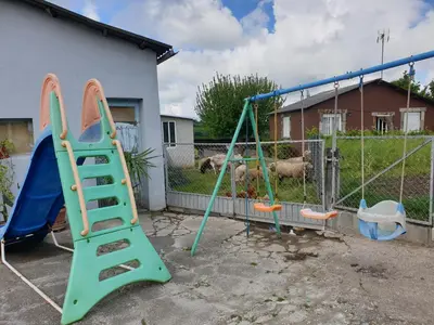 a playground with two swings and a slide at ANAMAR in Lugo