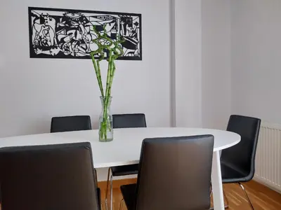 a white table with chairs and a vase of flowers on it at Adiva Praia Miño in Miño