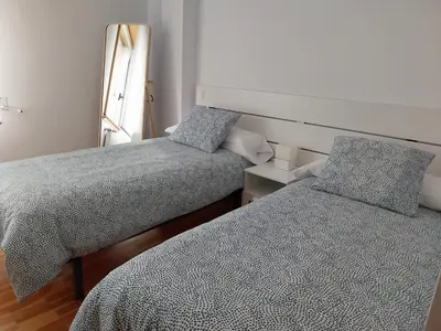 a bedroom with two beds and a window at Adiva Praia Miño in Miño
