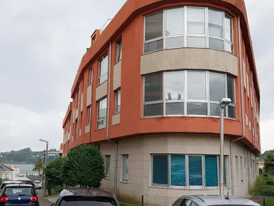 a building with cars parked in front of it at Adiva Praia Miño in Miño