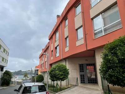 a car parked in front of a red building at Adiva Praia Miño in Miño