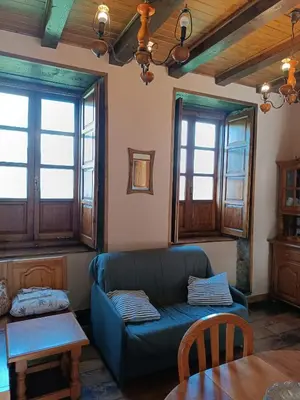 a living room with a couch and a table at Apartamentos Rurales San Esteban de los Buitres - Illano in San Esteban