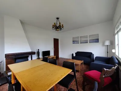 a living room with a wooden table and chairs at Casa A Mariña in Barreiros