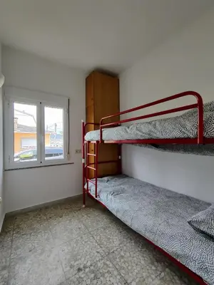 a room with two bunk beds and a window at Casa A Mariña in Barreiros