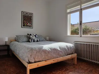 a bedroom with a bed and a window at Casa A Mariña in Barreiros