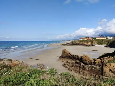 a view of a beach with rocks and the ocean at Casa A Mariña in Barreiros